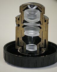 Photo of a microscope objective cut in half. The arrangement of the various lenses inside the objective is visible